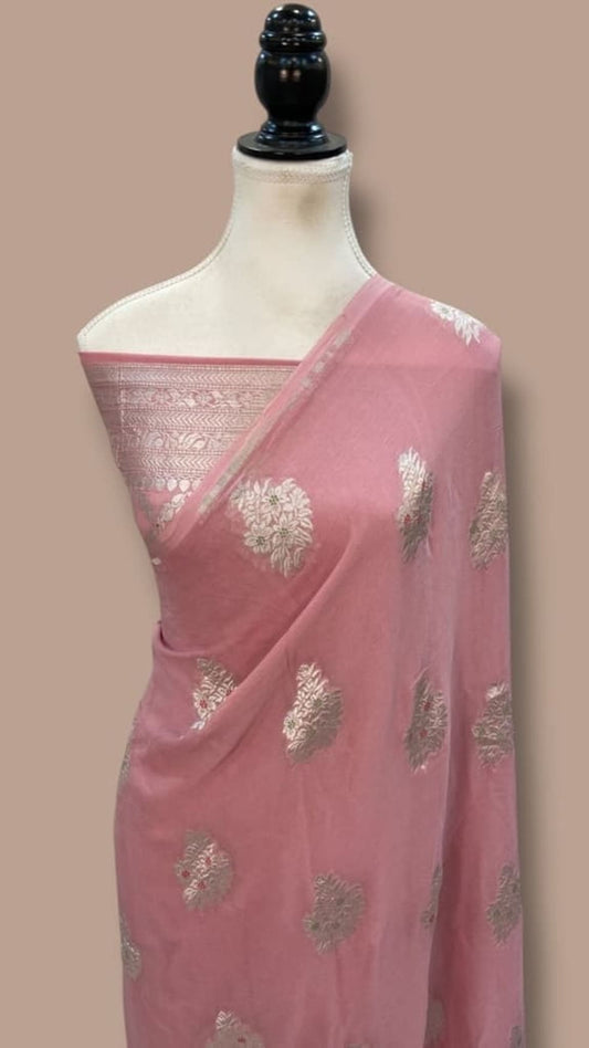 Pink Banarasi georgette saree draped on mannequin, silver zari border and teardrop motifs