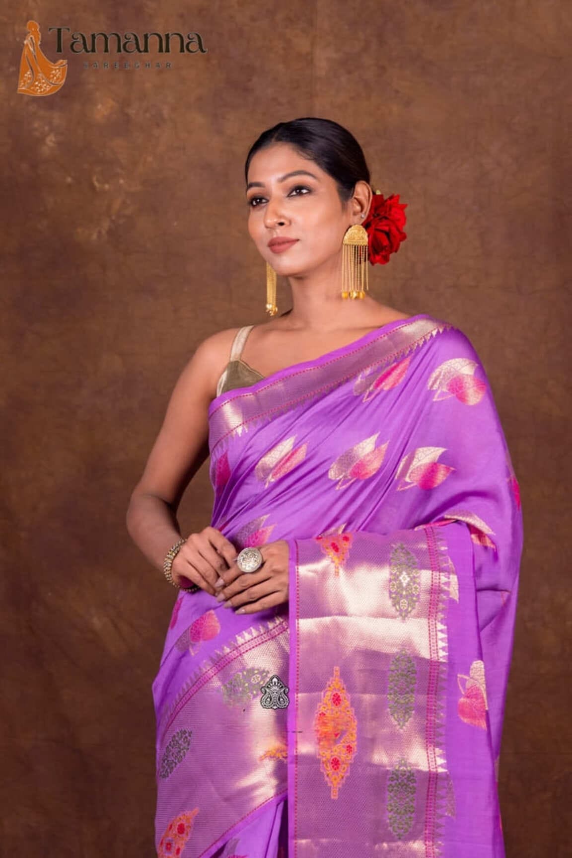 Lavender banarasi saree with gold border and jewel-toned motifs on pleats