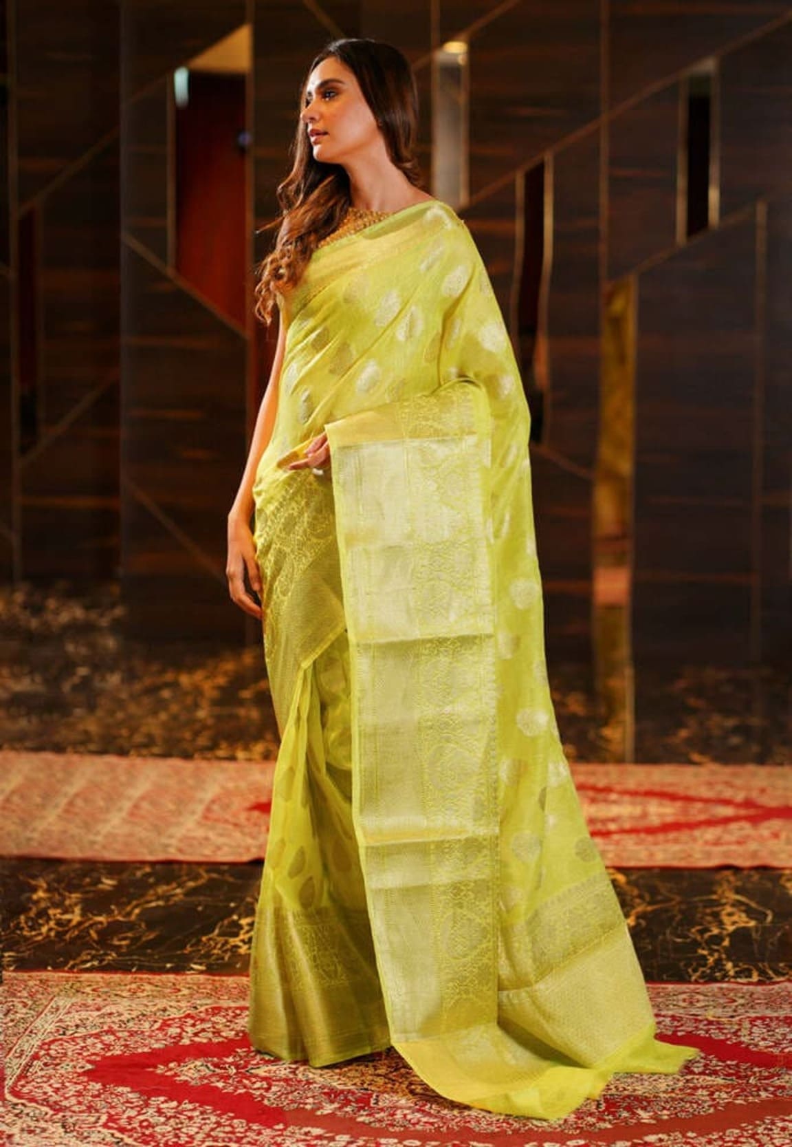 Lemon yellow linen Banarasi saree, side profile with patterned pallu and border