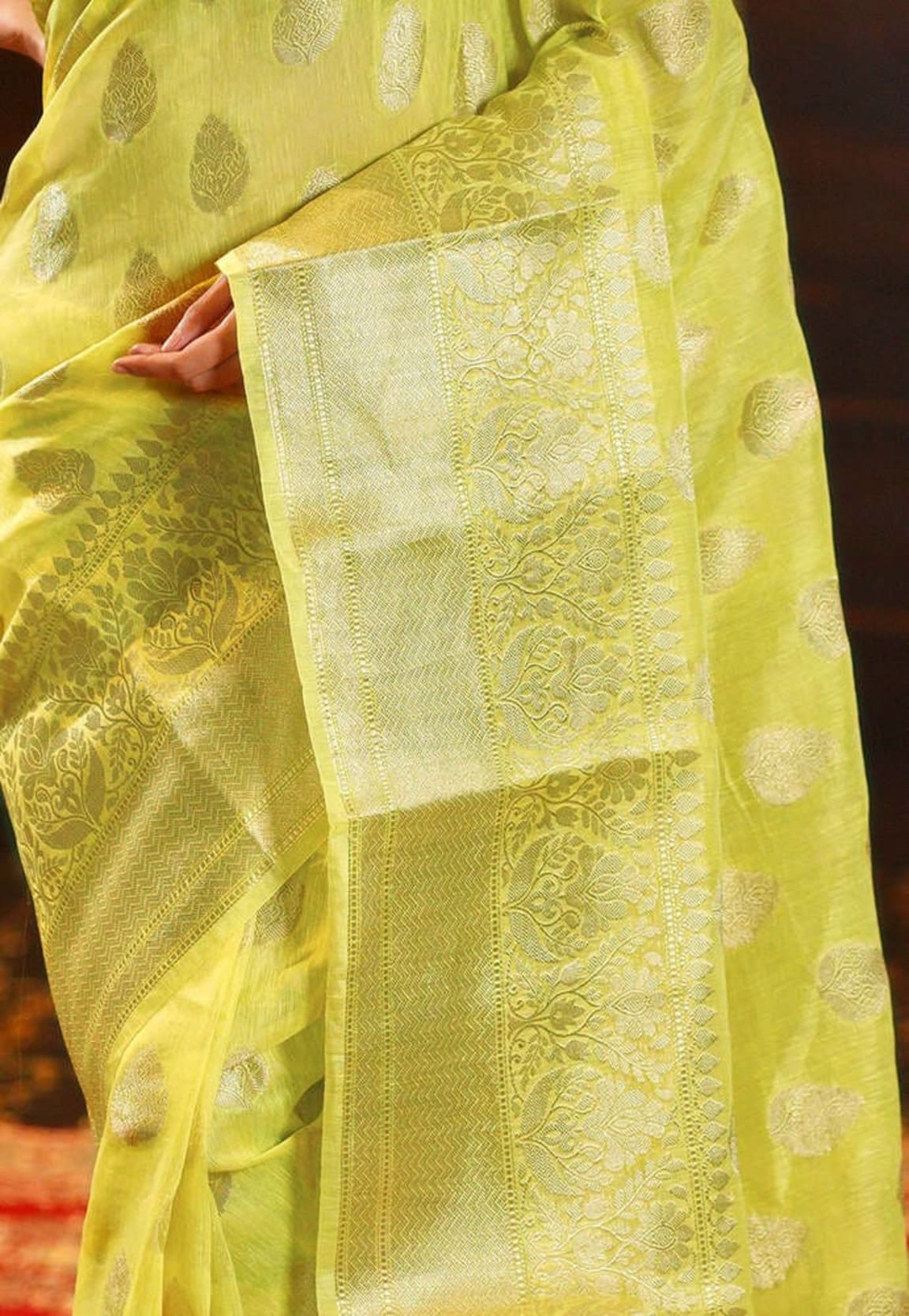 Lemon yellow linen Banarasi saree close-up of ornate pallu panel and border