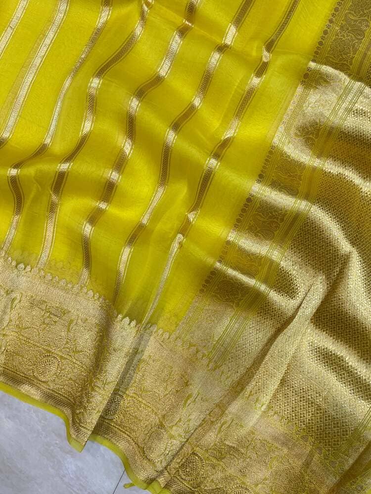 Lemon yellow saree fabric with gold zari check-and-stripe pattern and woven edge