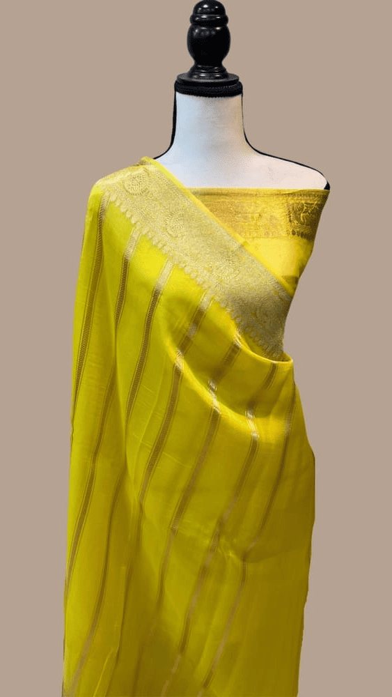 Lemon yellow Banarasi saree with gold zari pallu draped over shoulder