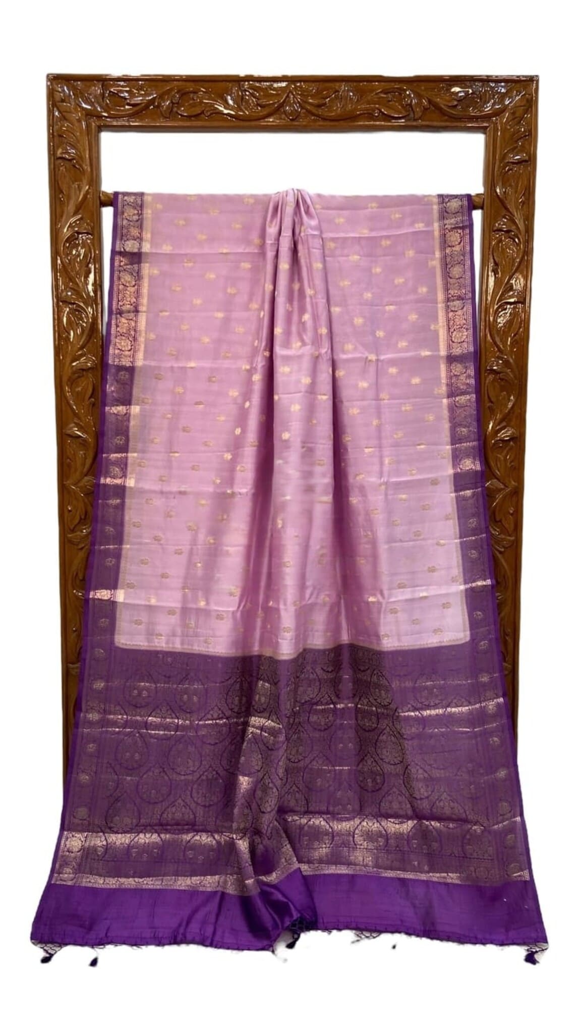 Light purple silk saree folded display, featuring dark purple border and gold motif lines.