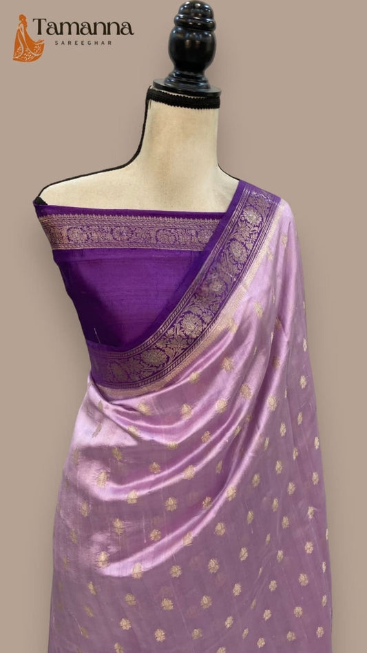 Light purple silk saree with dark purple woven pallu border and scattered gold motifs.