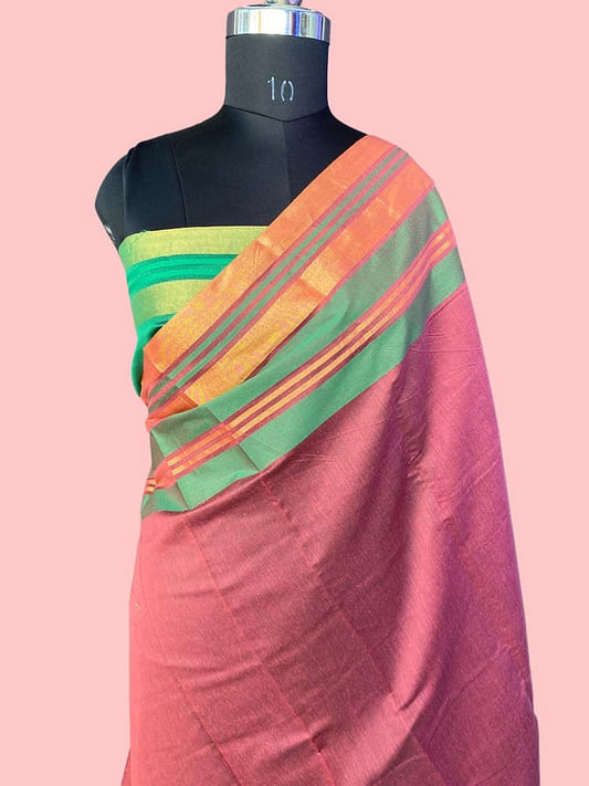Silk saree draped on mannequin: magenta body with green-orange multicolor border