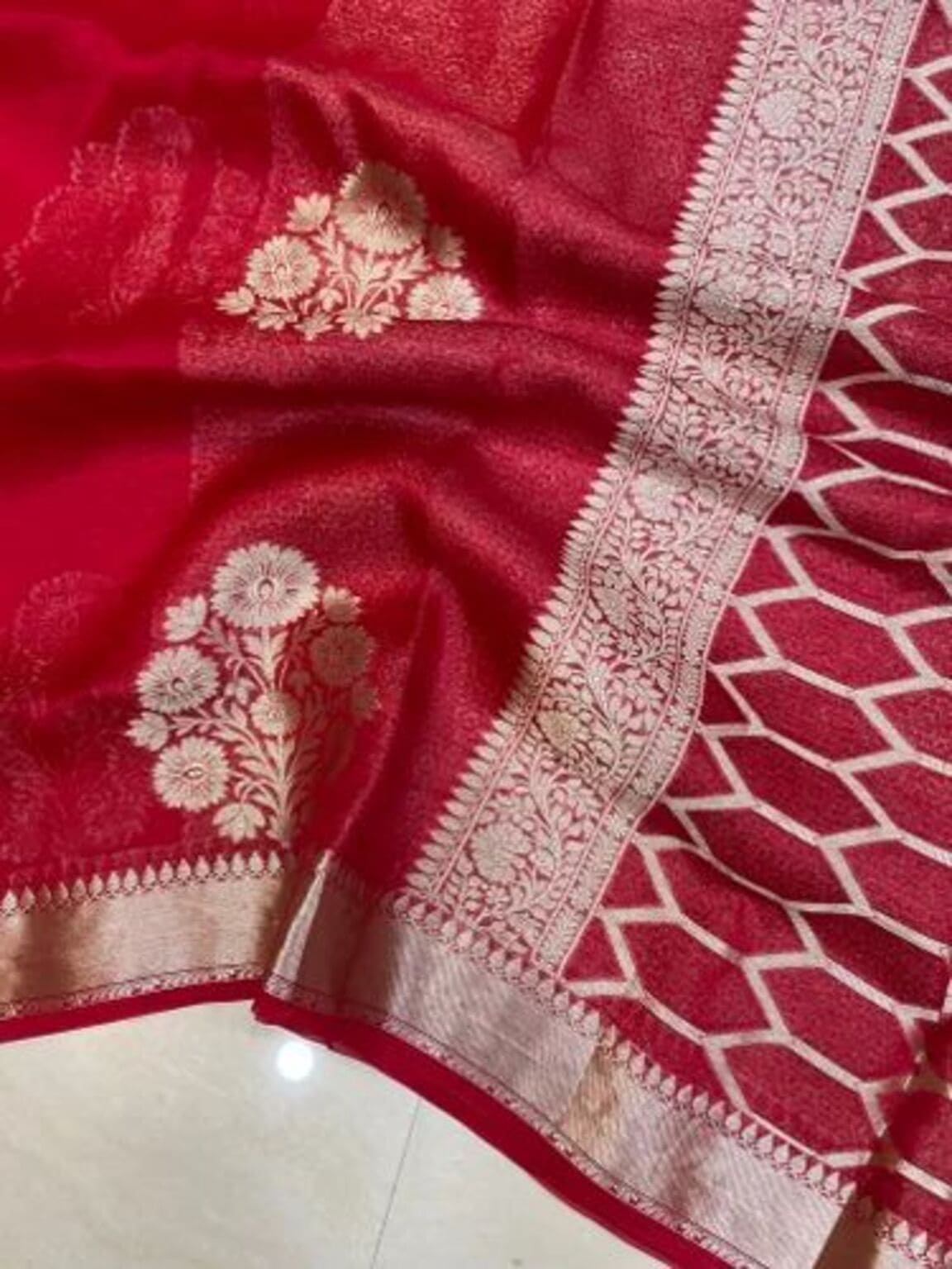 Red saree fabric with floral butta and wide woven silver-gold border