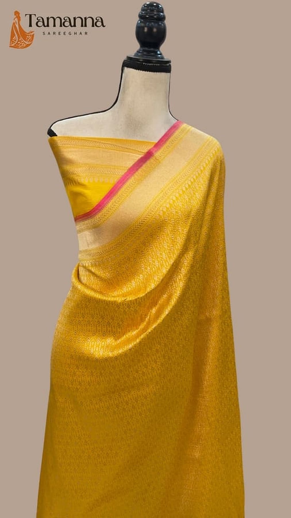 Mango yellow silk saree with pink border stripe and subtle zari sheen, draped close-up