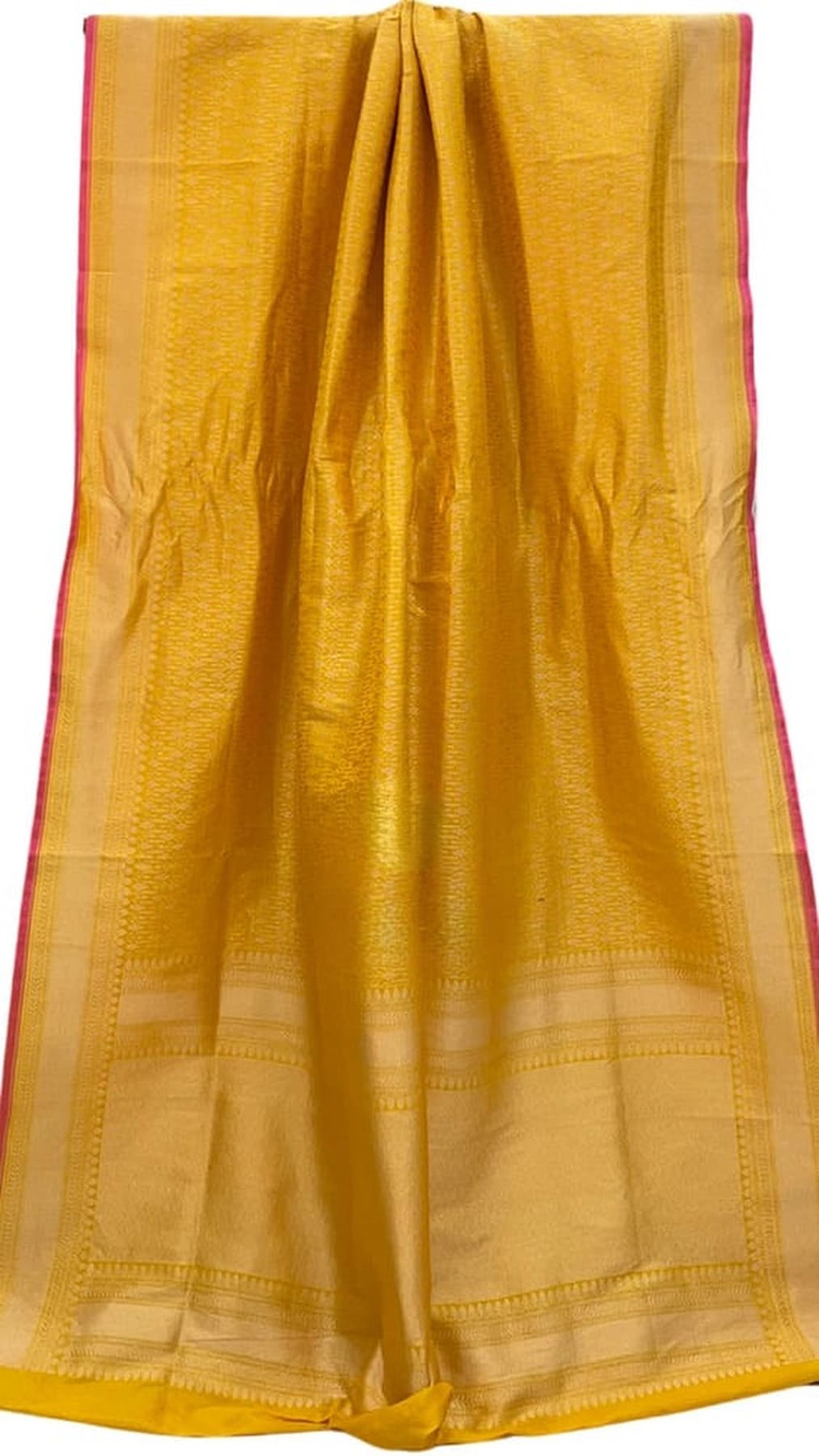 Mango yellow silk saree with wide pink border and woven gold grid, folded cloth