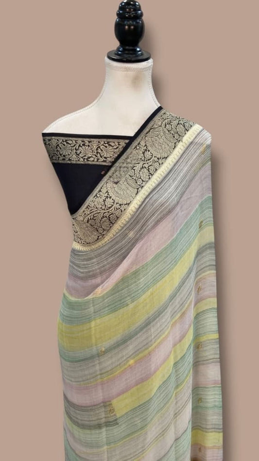 Pastel multicolor striped saree with dark border and gold zari motifs, draped