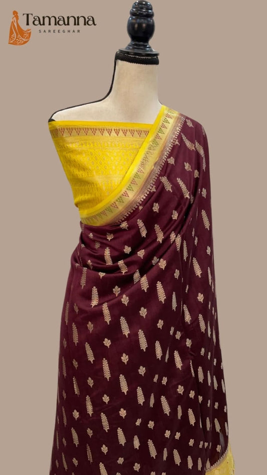 Maroon saree with golden-yellow pallu edge and repeating gold motifs, draped