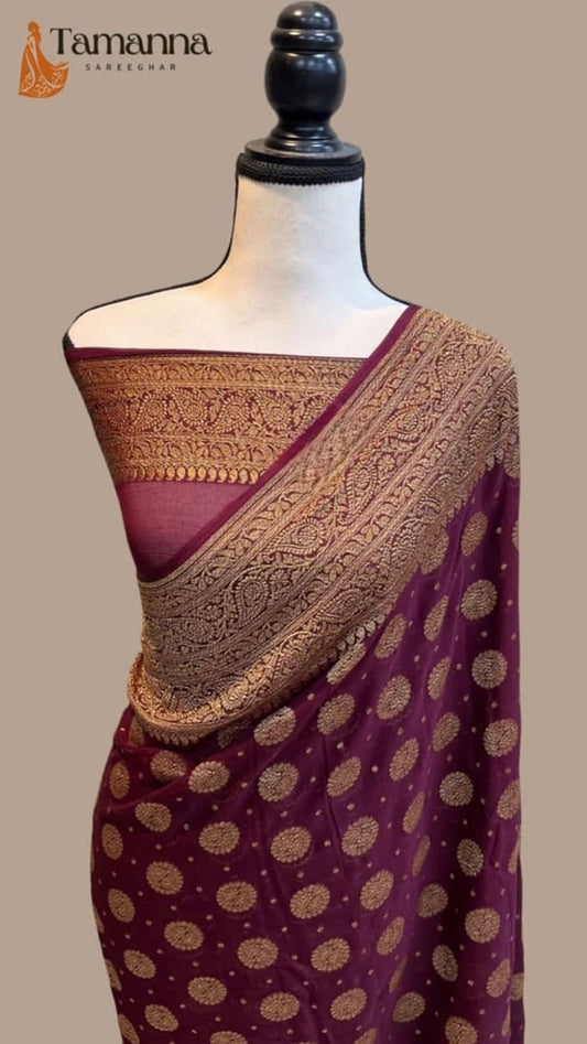 Maroon georgette saree pallu with gold zari pattern and circular dot motifs on drape