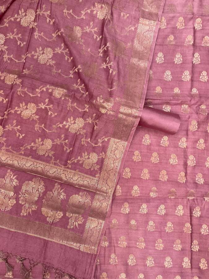Mauve silk fabric close-up with gold floral motifs, check-like pattern, and zari edge border