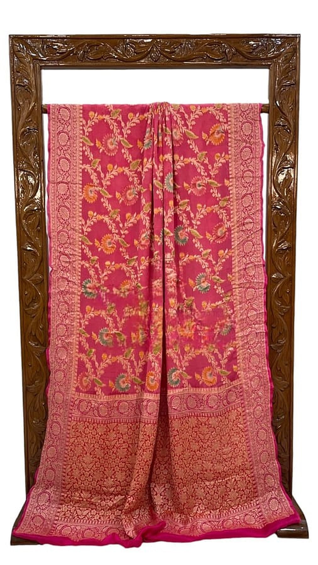 Melon pink saree folded display, gold motifs with broad zari border