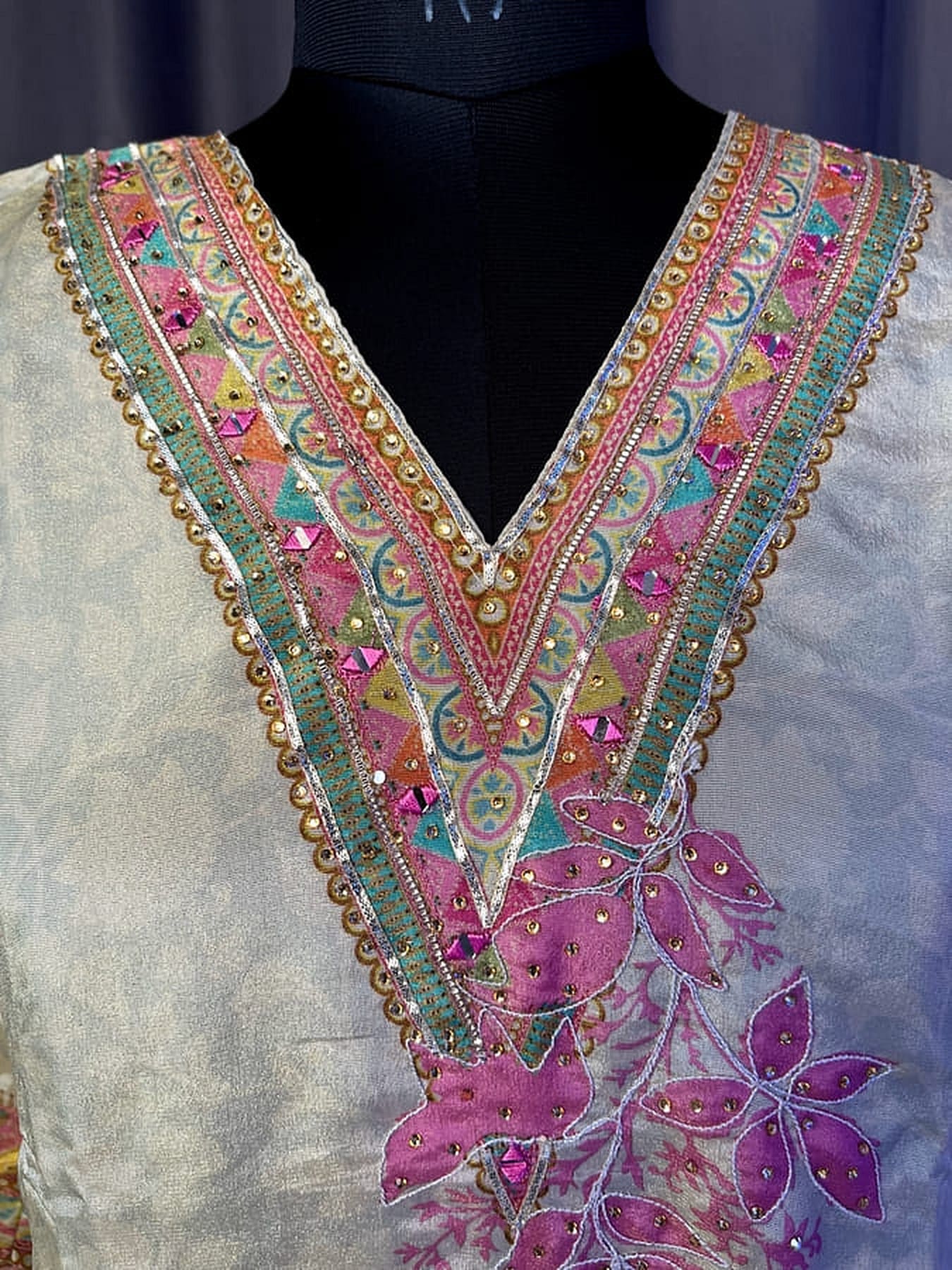 Embroidered V-neck kurta neckline with gold beads, multicolor trim and purple applique