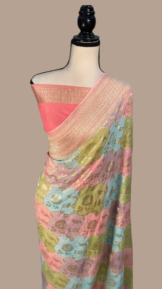 Multi-shaded Banarasi saree with floral motifs and zari border, draped on mannequin