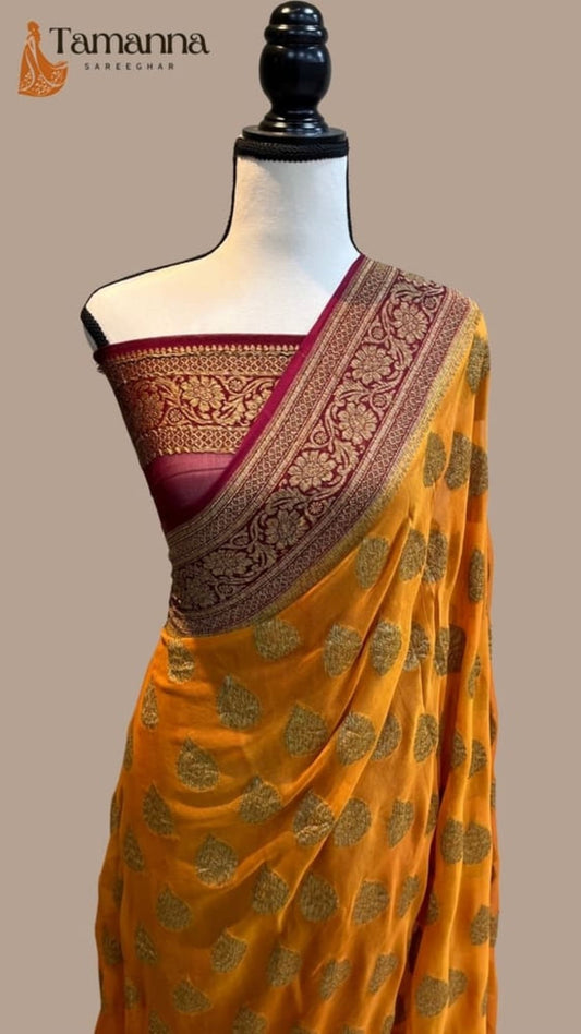 Mustard saree with maroon and gold pallu border, green-gold motif detailing
