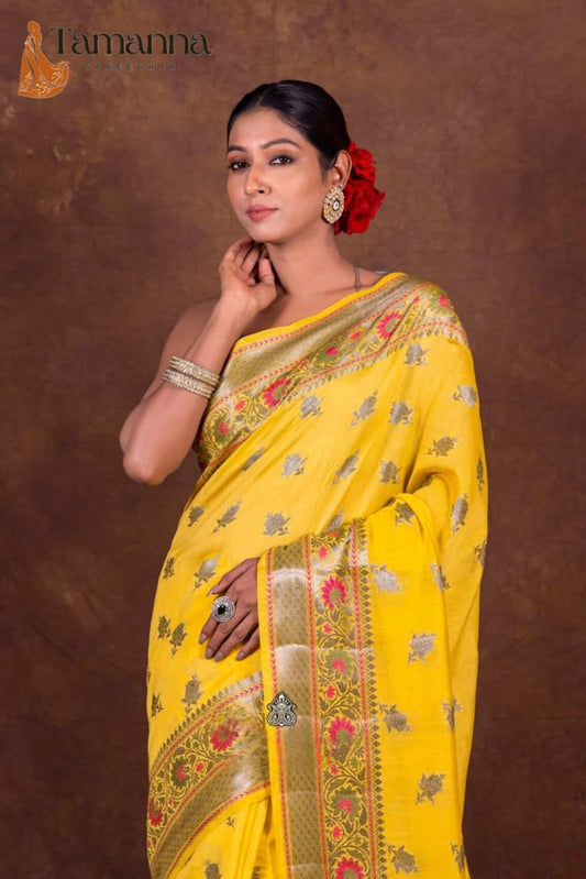 Yellow saree close view with multicolor floral motifs and gold zari border