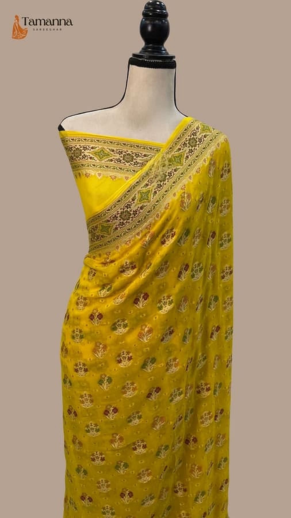 Mustard yellow saree featuring silver-toned zari border and repeated floral motifs
