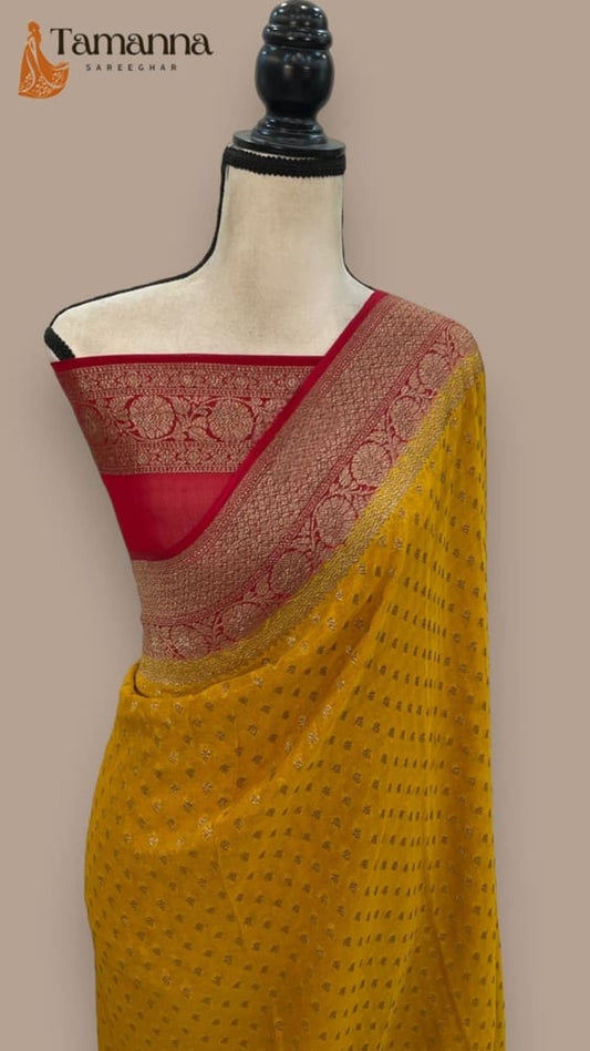 Mustard Banarasi saree with red blouse panel and gold-toned patterned pallu