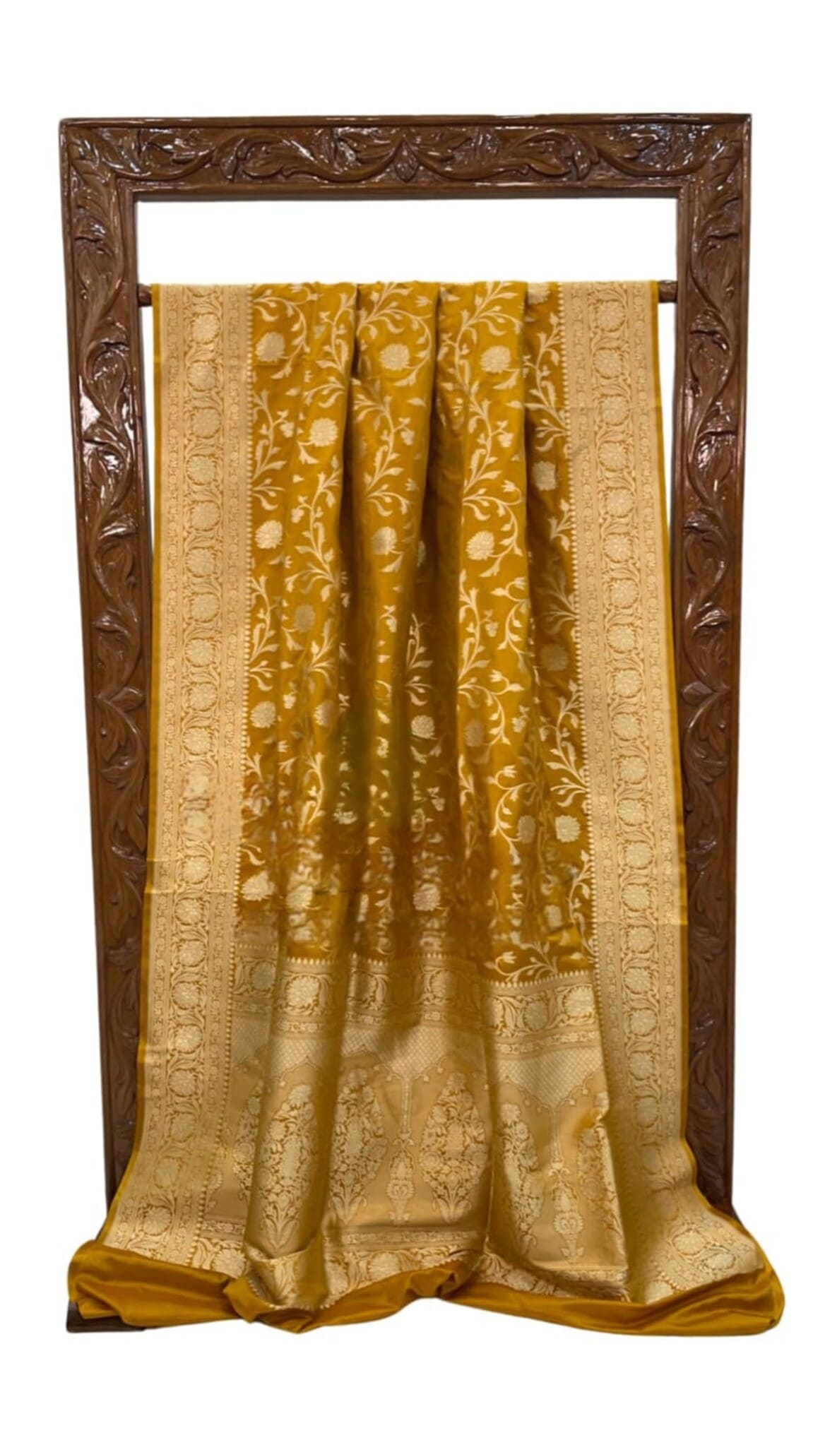 Mustard silk saree, front view laid flat, showing gold jaal work and zari border.