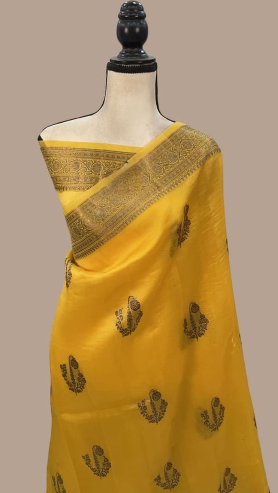Mustard yellow pure silk Banarasi saree with gold patterned border and leaf motifs