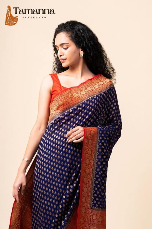 Navy blue saree with tiny gold dots and rust-gold pallu border over shoulder