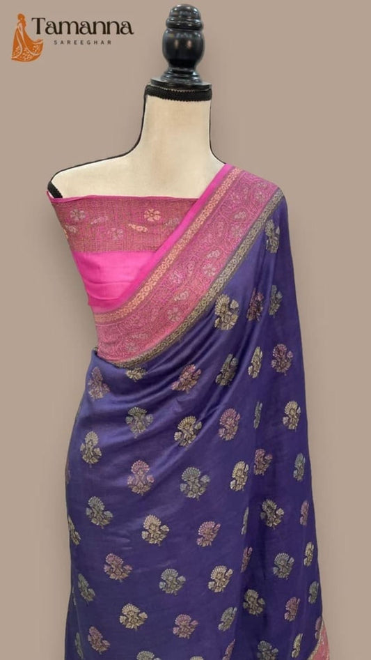 Navy blue saree with gold floral motifs and wide magenta pallu border