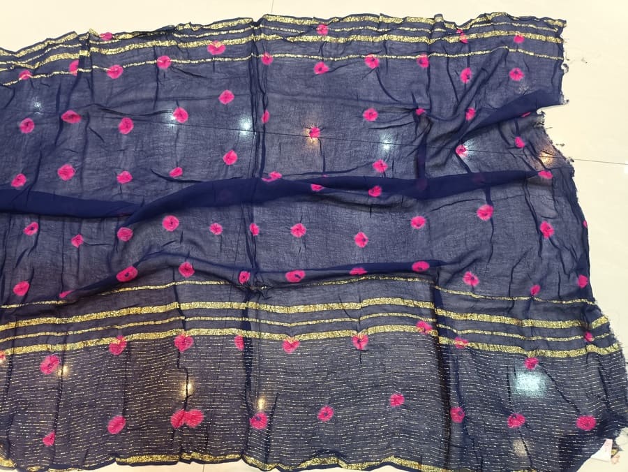 Navy chiffon saree panel with scattered pink motif circles and gold zari band