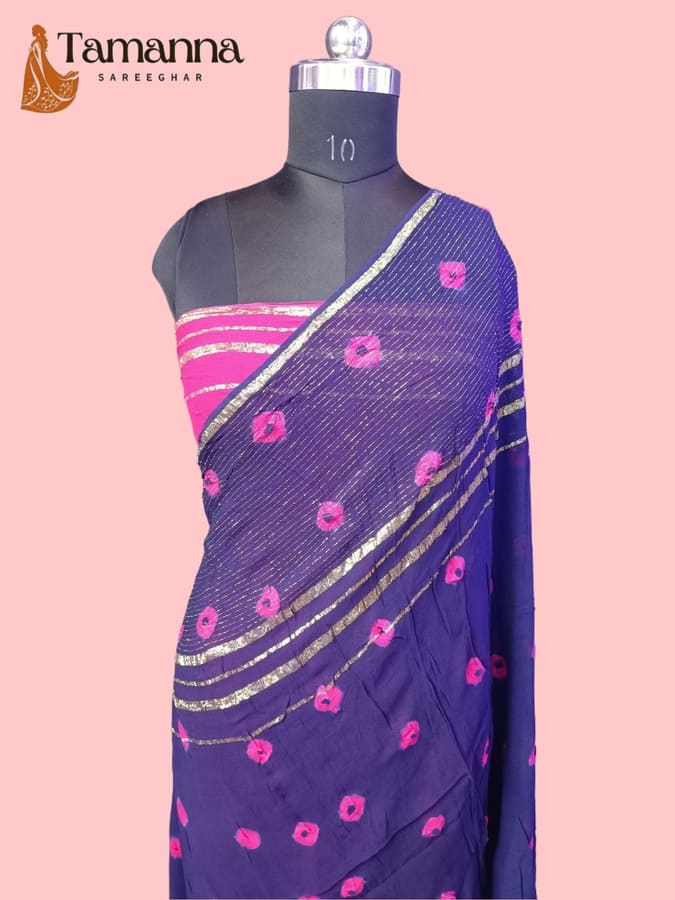 Navy chiffon saree drape with bandhani motifs, gold zari edging and pink pattern