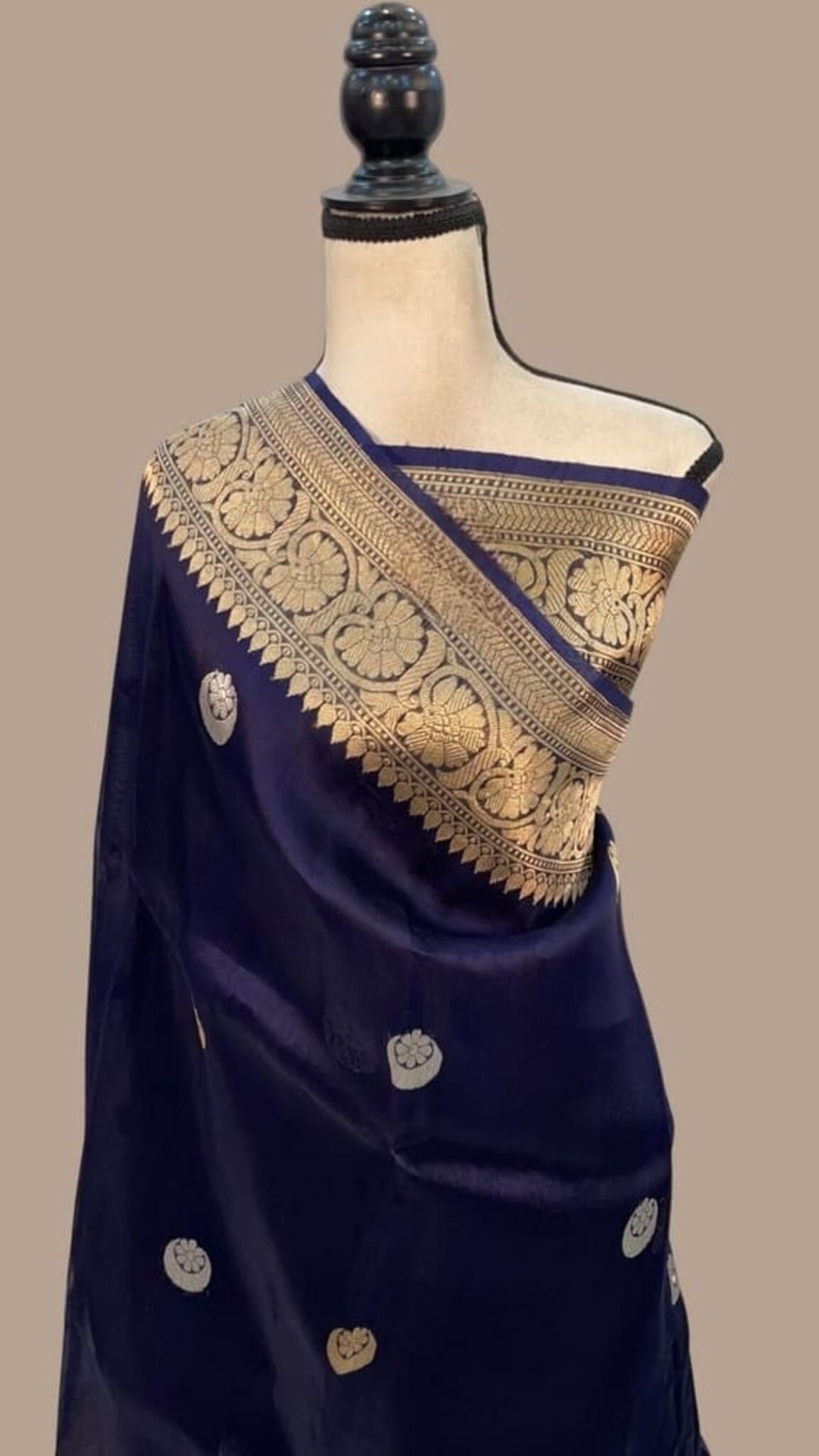 Navy blue saree with gold zari border, embellished pallu, and round coin motifs