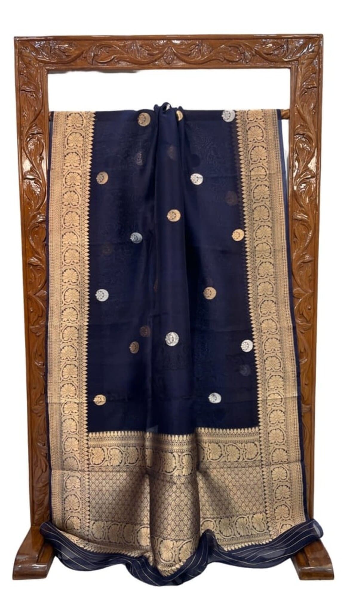 Navy blue saree with ornate gold border and dotted circular embellishments, draped
