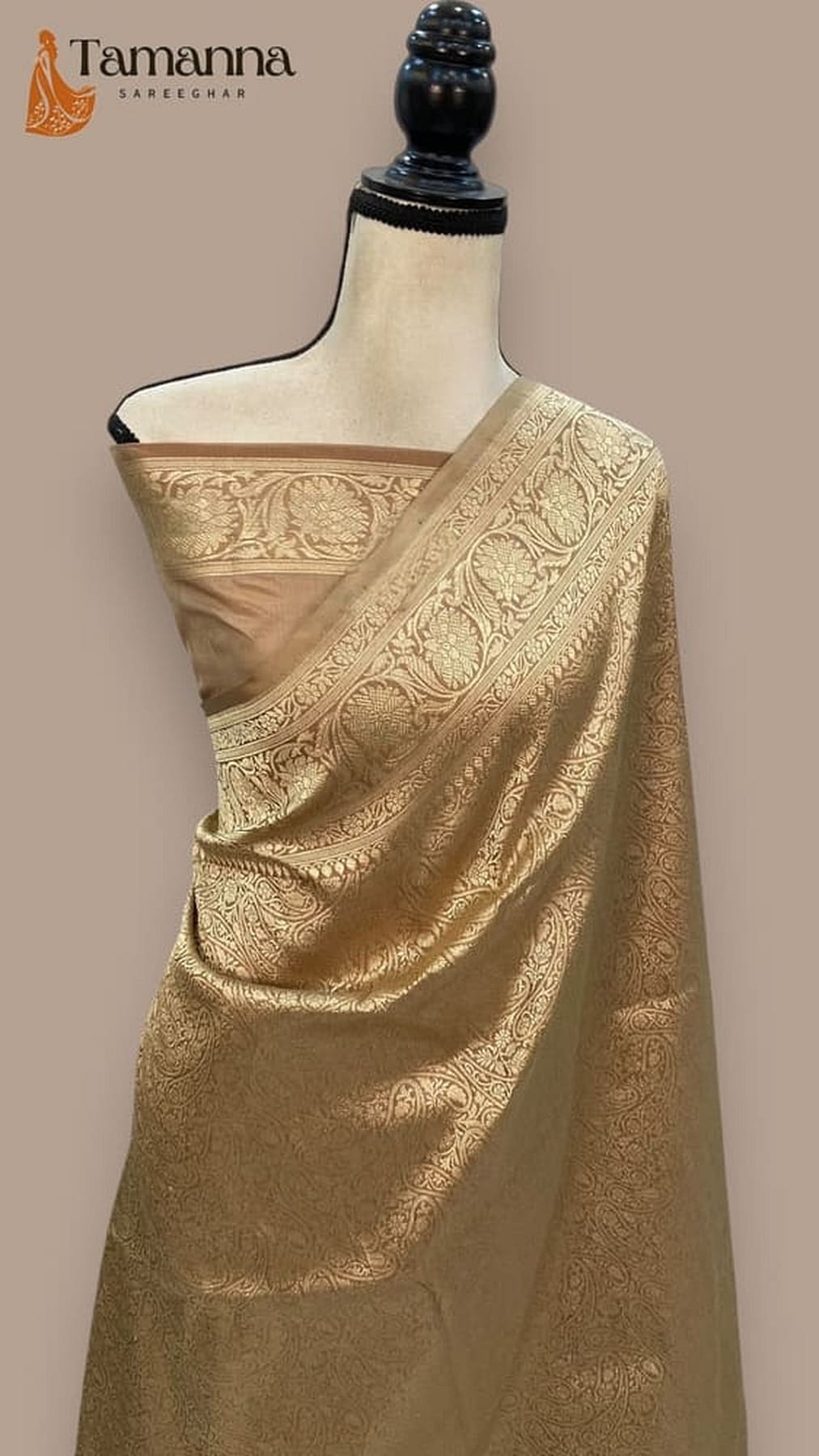 Gold Banarasi silk saree with ornate woven motifs and broad drape border