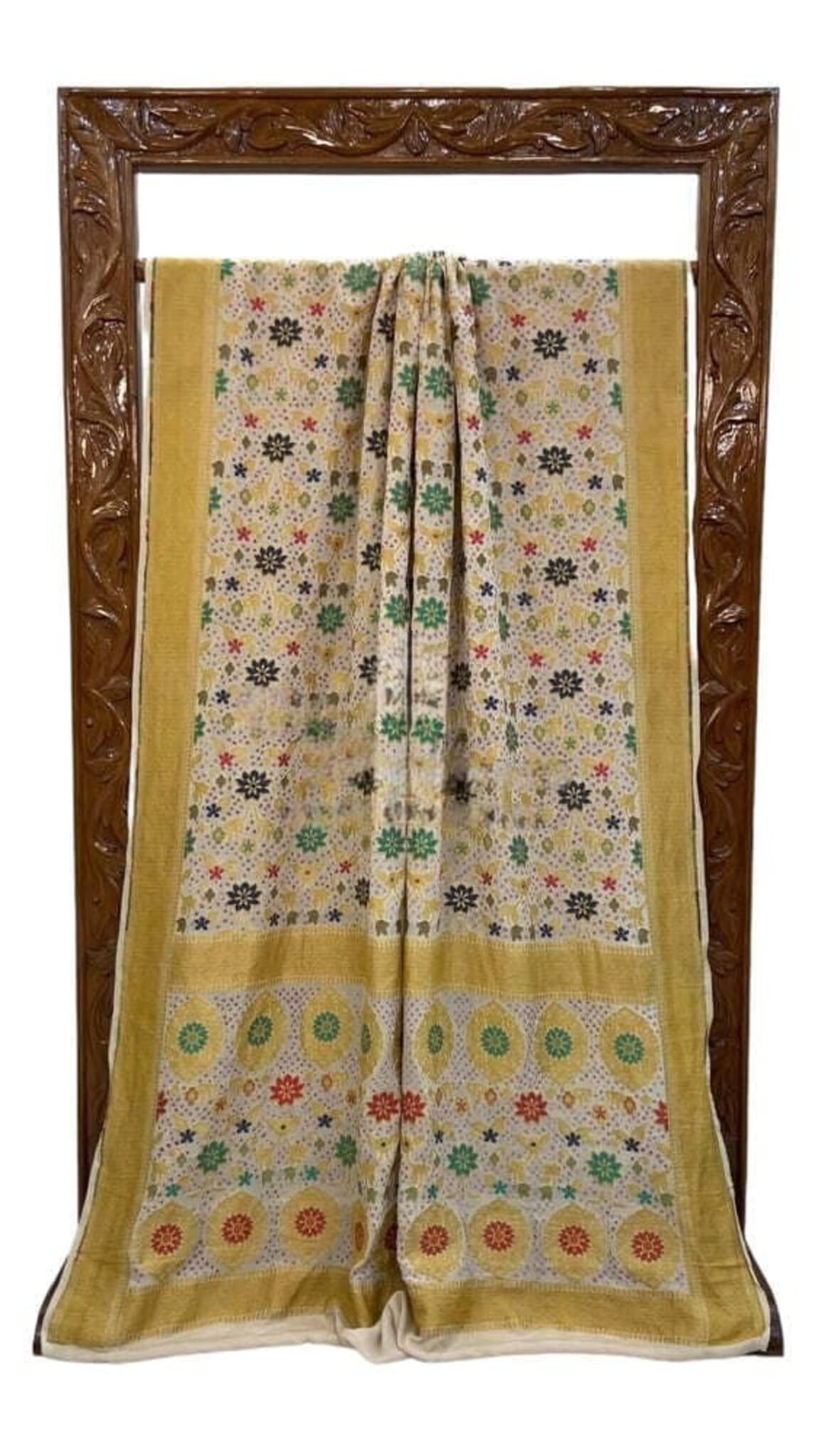 Off-white saree with mustard-yellow border, multicolor floral motifs, front folded view