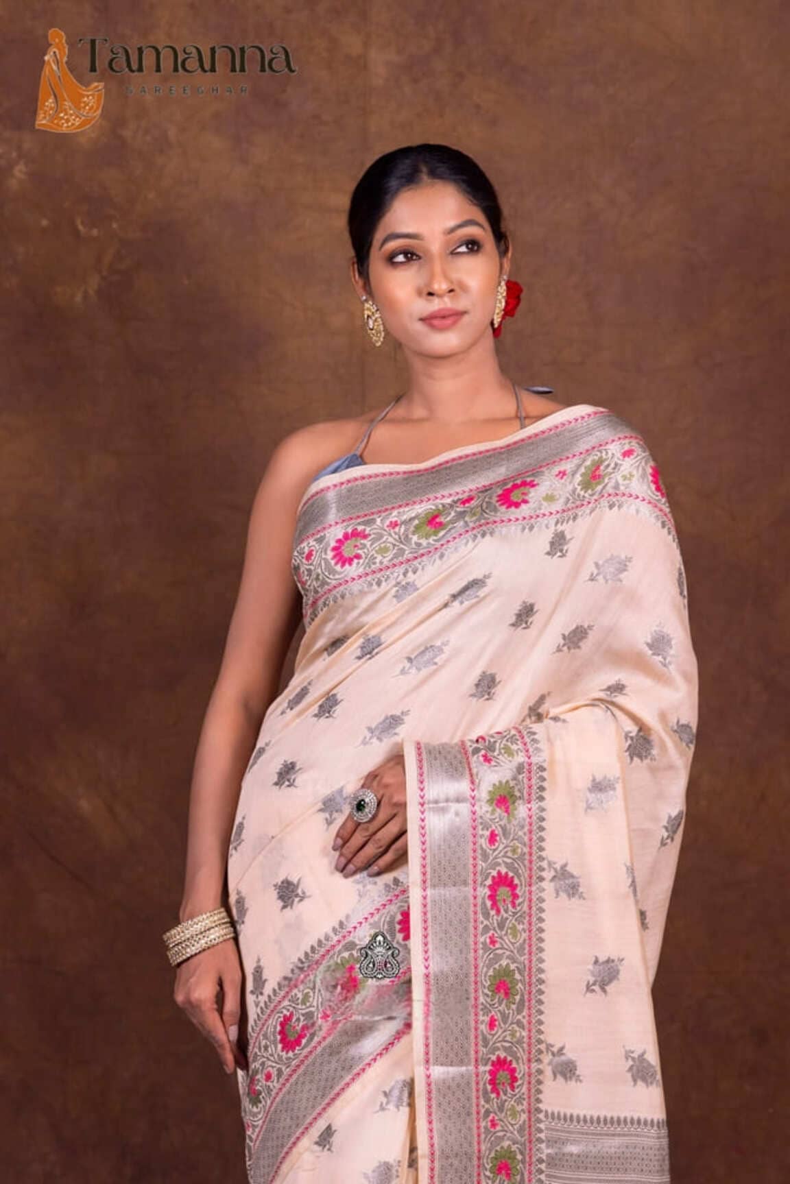 Off-white Banarasi chanderi saree with navy floral prints and decorative pink-green panel