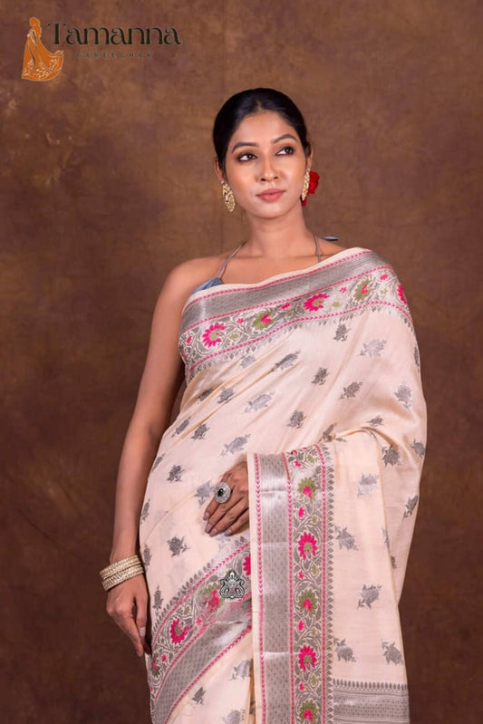 Off-white Banarasi chanderi saree with navy floral prints and decorative pink-green panel