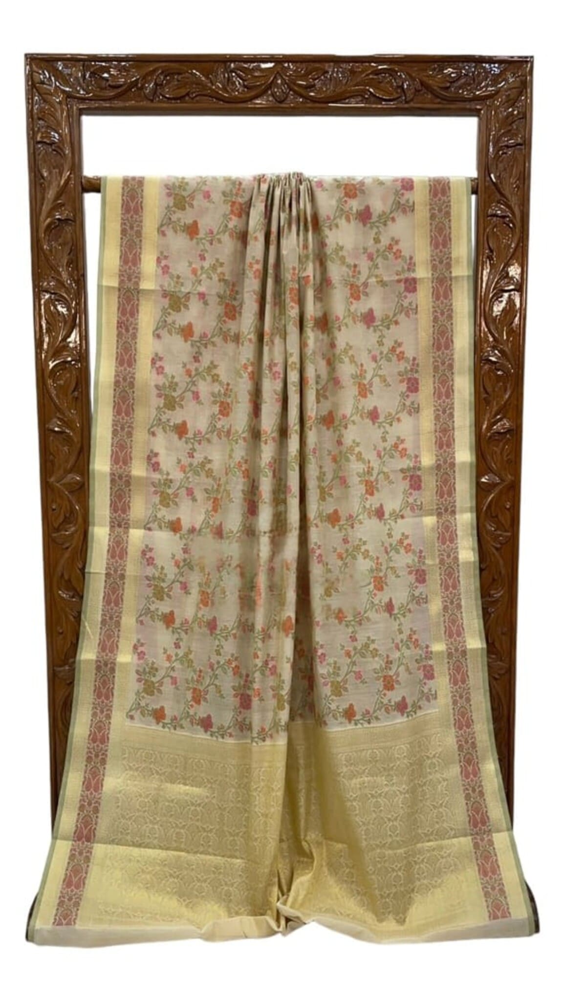 Cream cotton saree laid flat, floral motifs with pale gold section and maroon-pink border