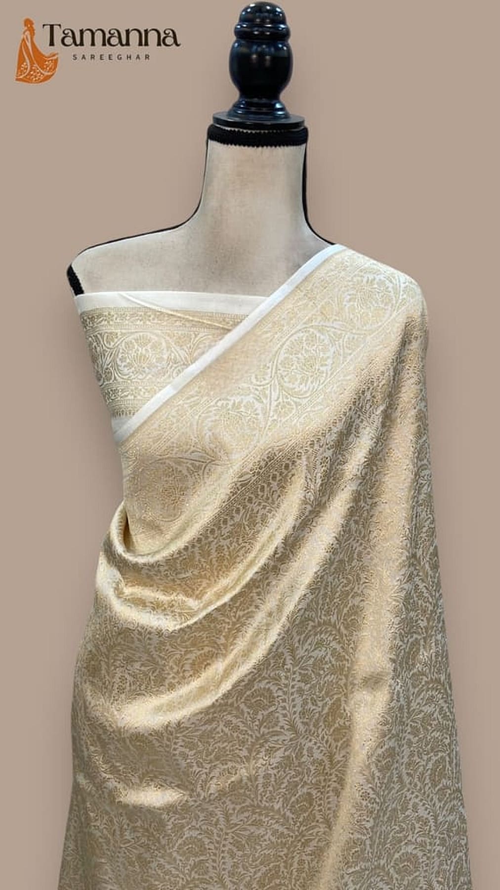 Off-white katan silk saree with gold-toned jacquard motifs and pale border on drape