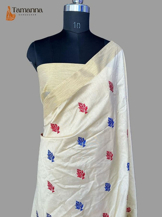 Off-white pure silk saree drape with red and blue butti motifs on one pallu