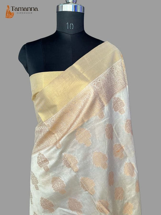 Off-white silk saree with gold zari pallu and all-over floral brocade