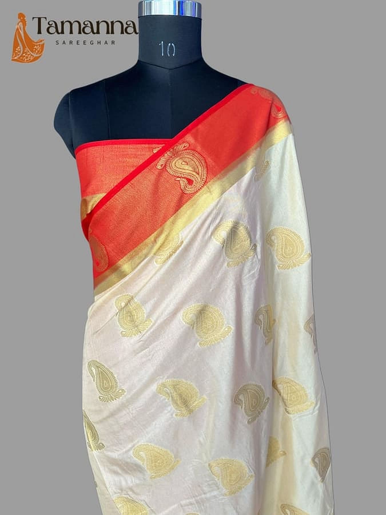Off-white silk Banarasi saree with golden zari motifs and red pallu on mannequin