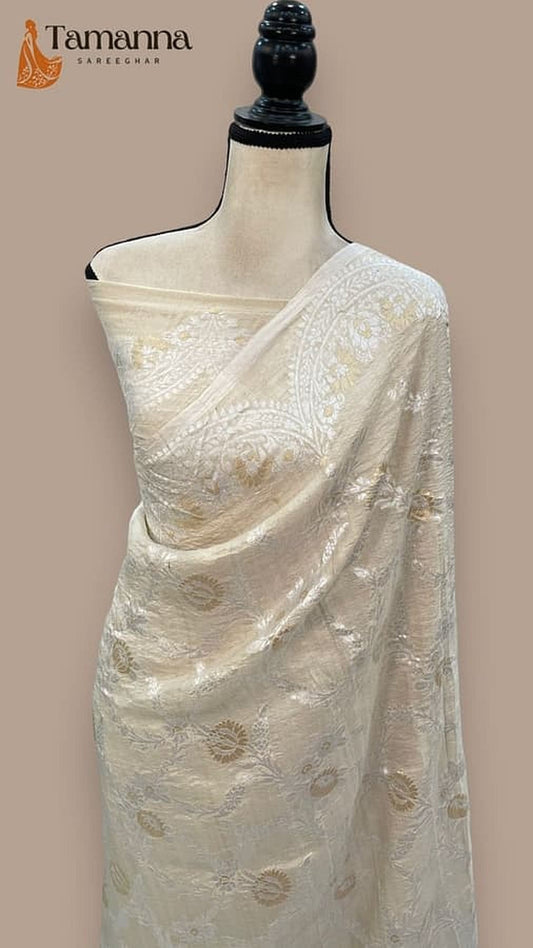 Off-white saree with pallu section and gold-toned woven motifs
