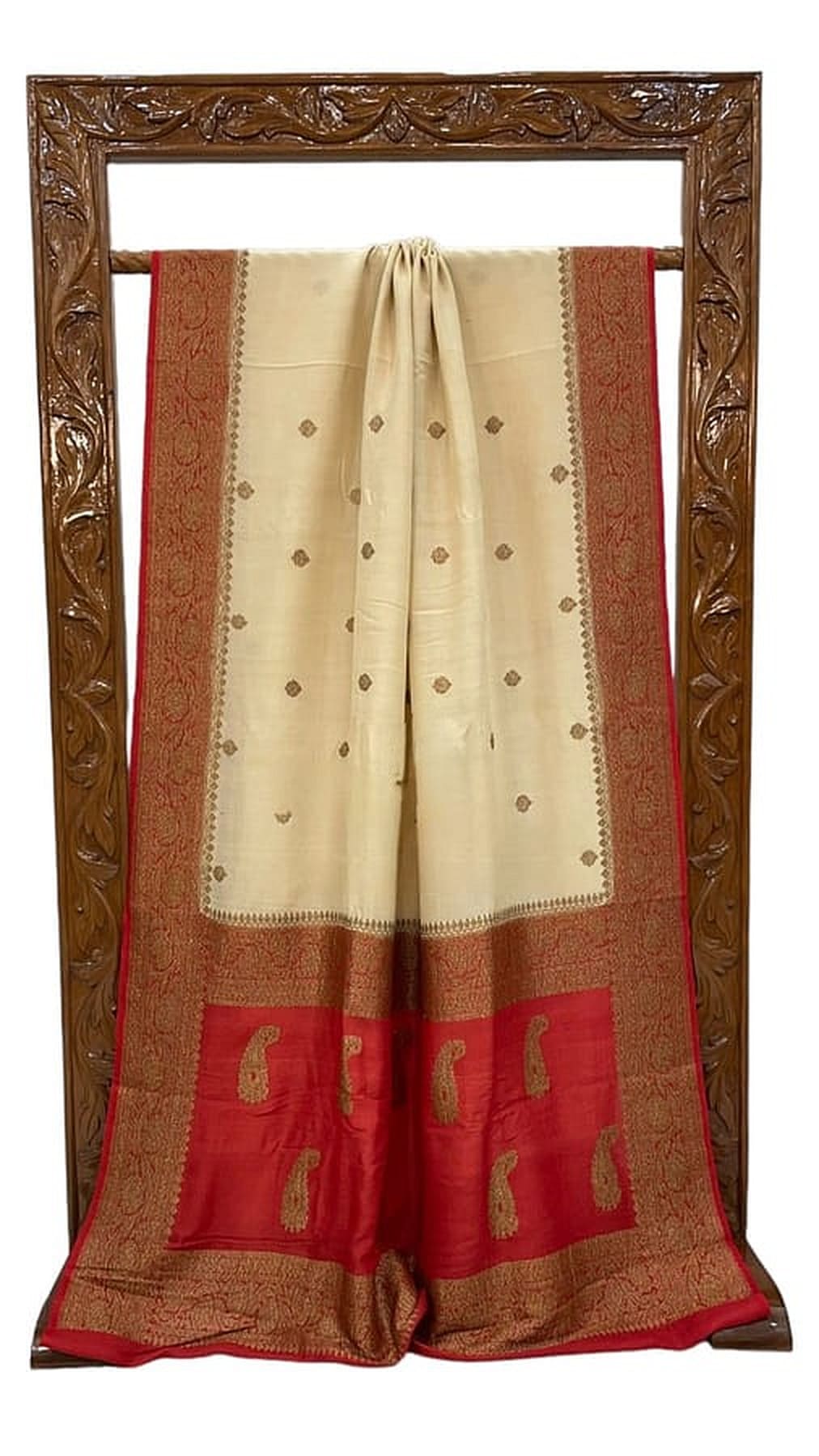 Off-white saree hanging display with gold border, all-over motifs, and red patterned hem