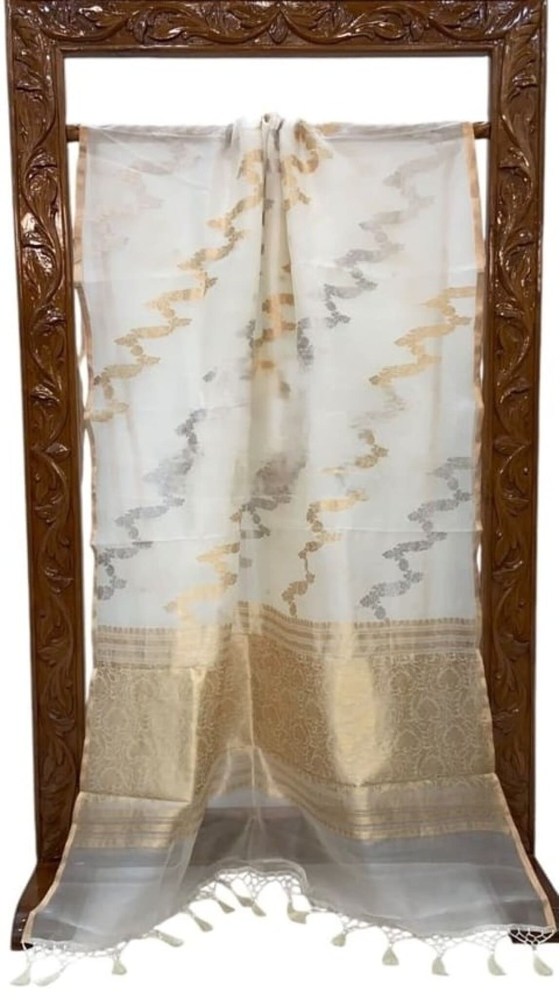 Off-white saree with gold and gray vine motifs, wide gold border and tassel ends