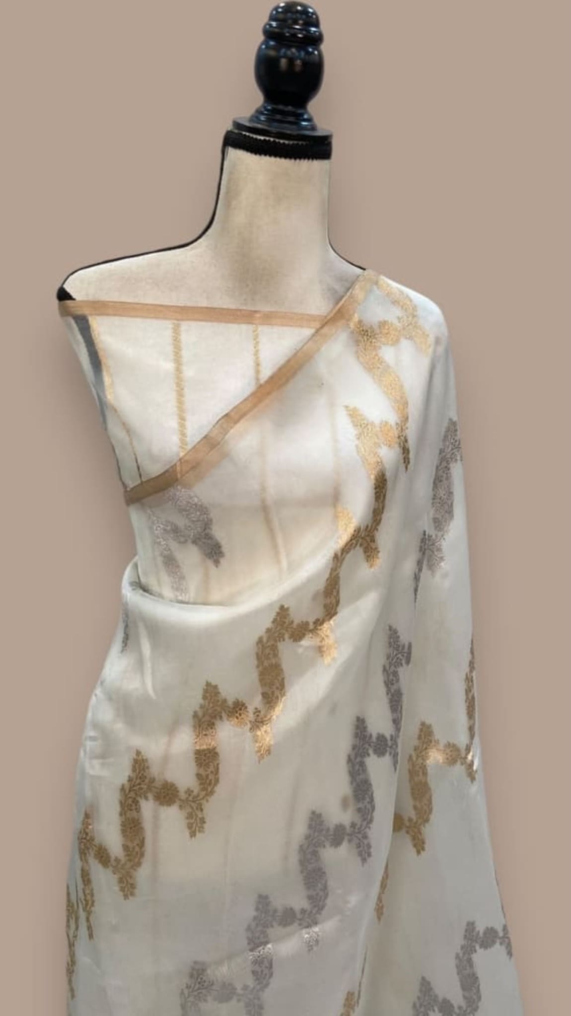 Off-white saree with gold and gray floral motifs and zari border drape