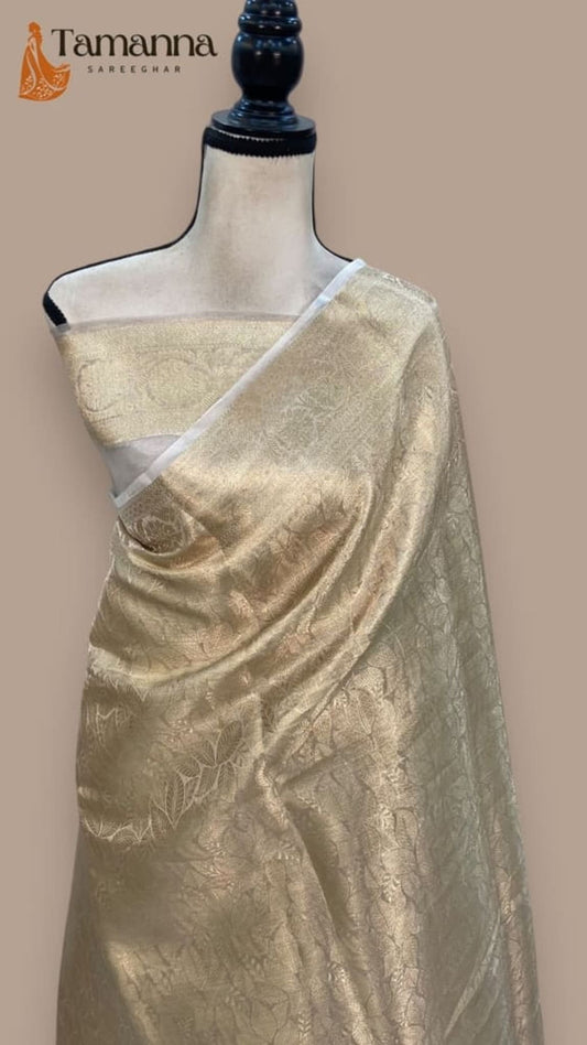 Off-white Banarasi saree, gold leaf motifs, diagonal border draped on mannequin
