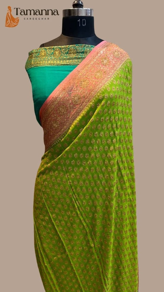 Olive green saree drape on mannequin with gold-trim border and peach-gold pallu