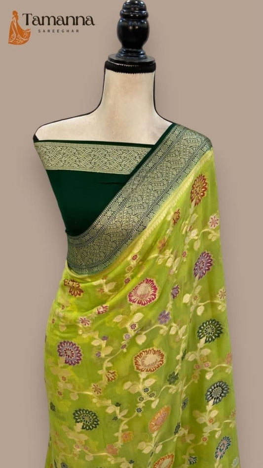 Lime green saree on mannequin with dark green pallu border and floral woven motifs