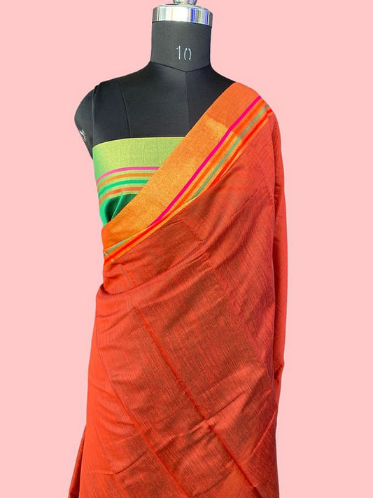 Orange pure silk saree with orange pallu and green border on mannequin