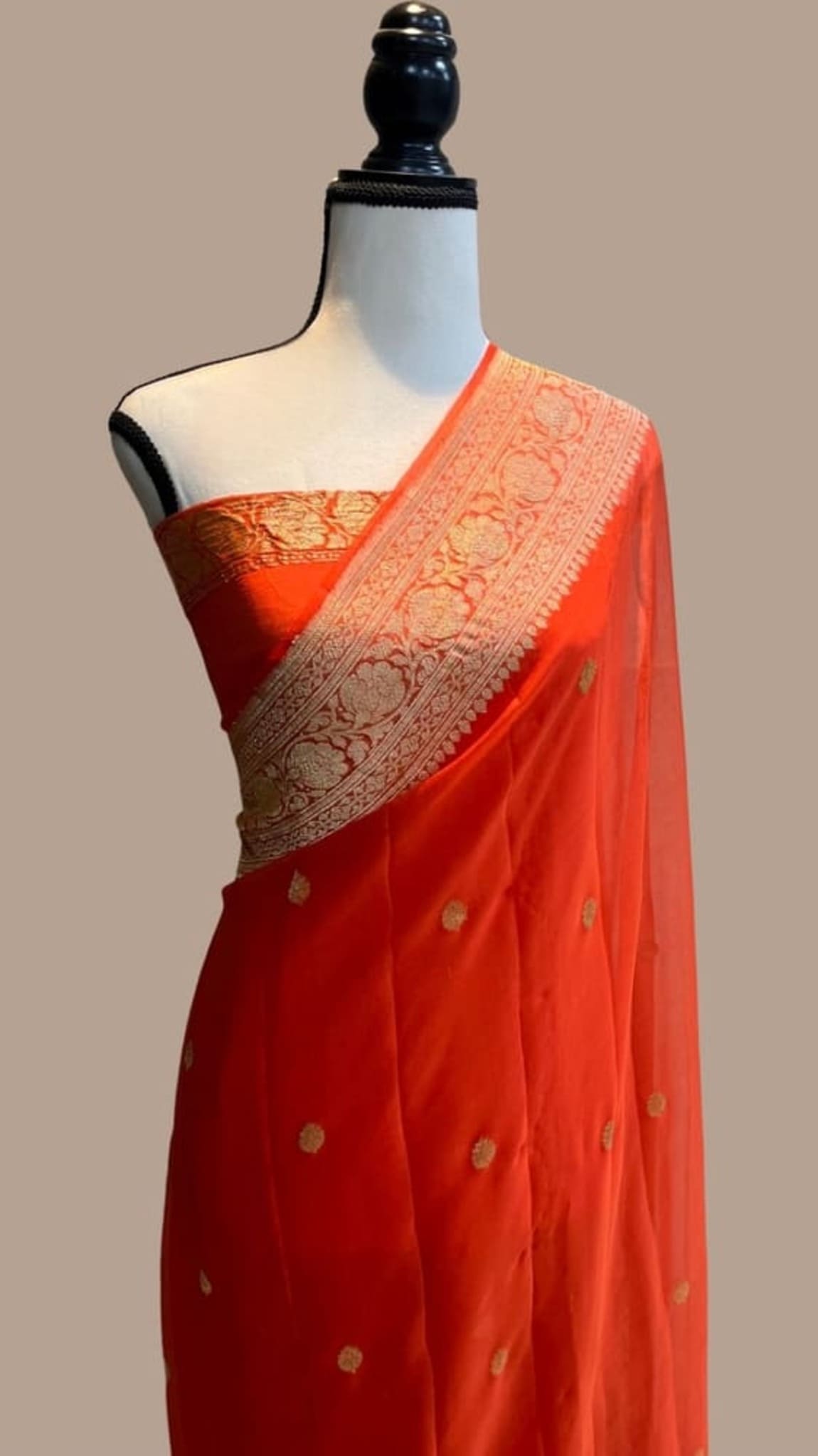 Orange saree drape with gold zari pallu border and embroidered dot motifs