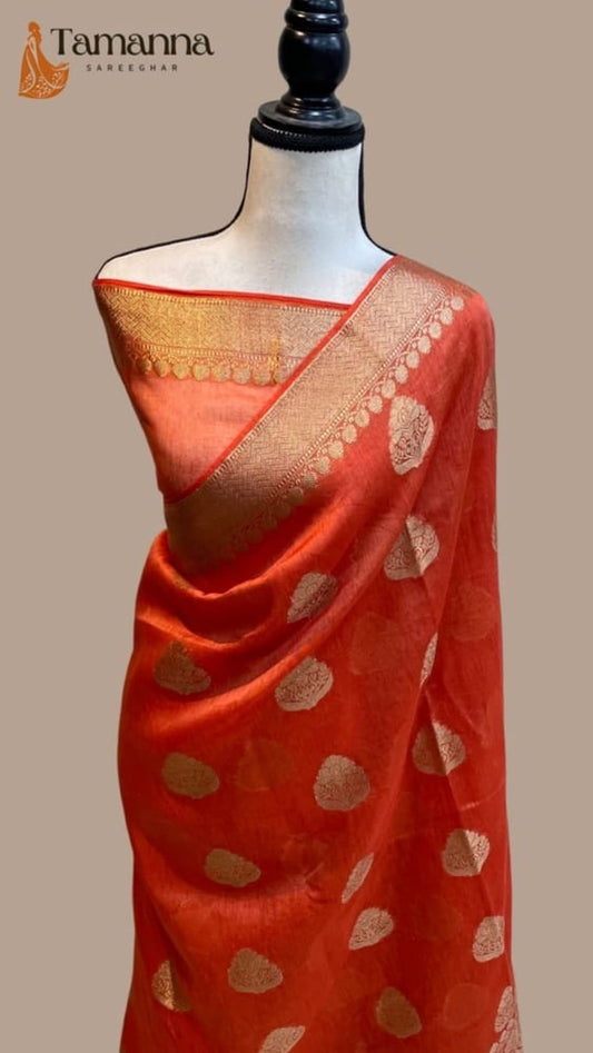 Orange sari with gold zari border and patterned pallu on mannequin